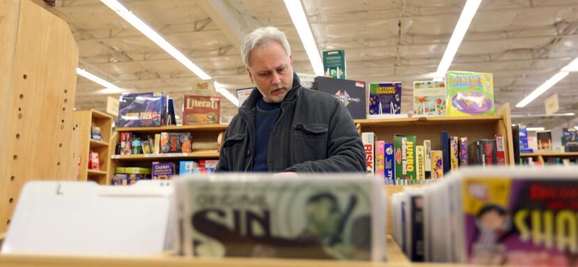 
Scott Harben of Plano looks through a rack of comic books at the new Half Price Books in...