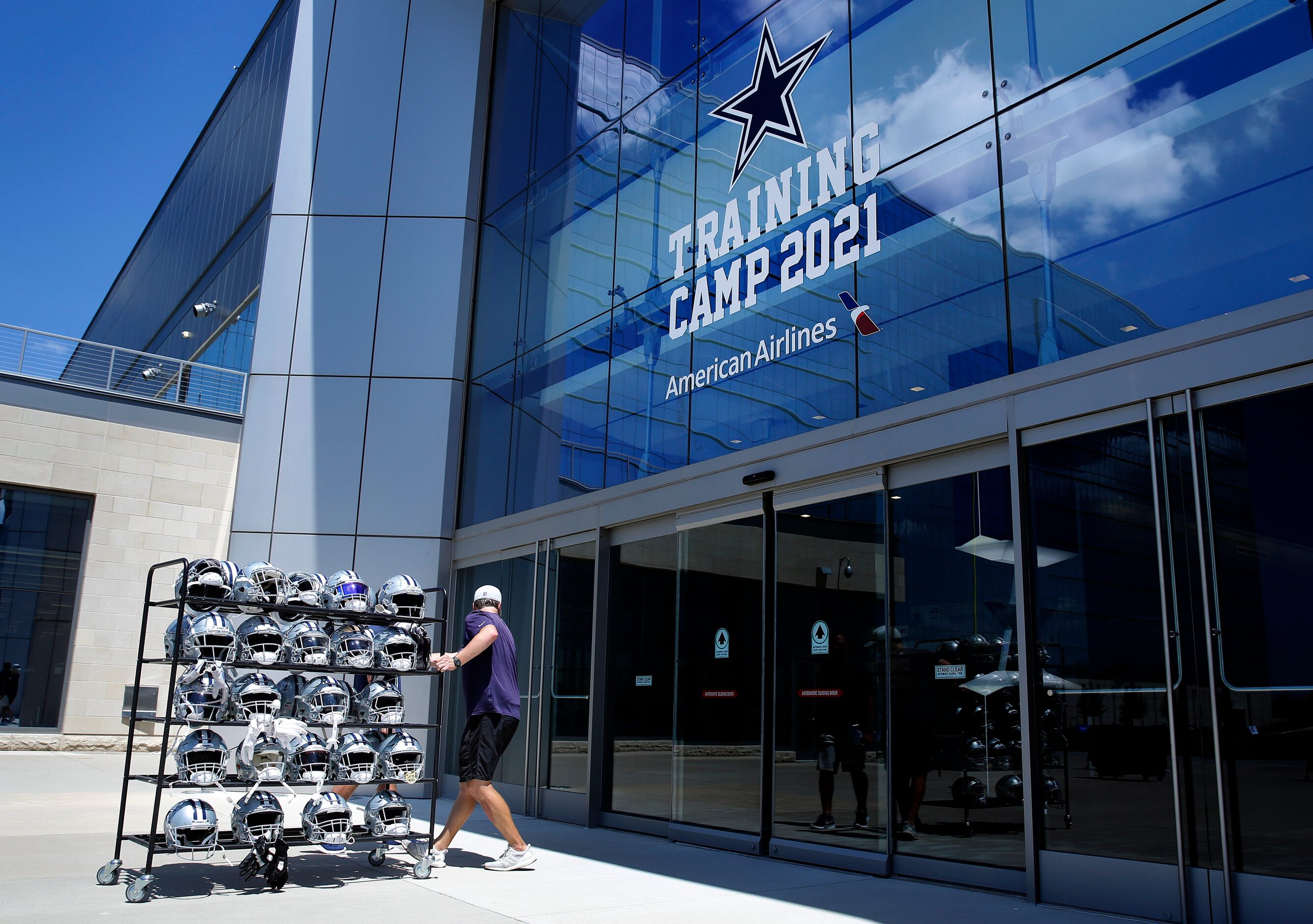 A rack full of players helmets are carted inside following Training Camp practice at The...