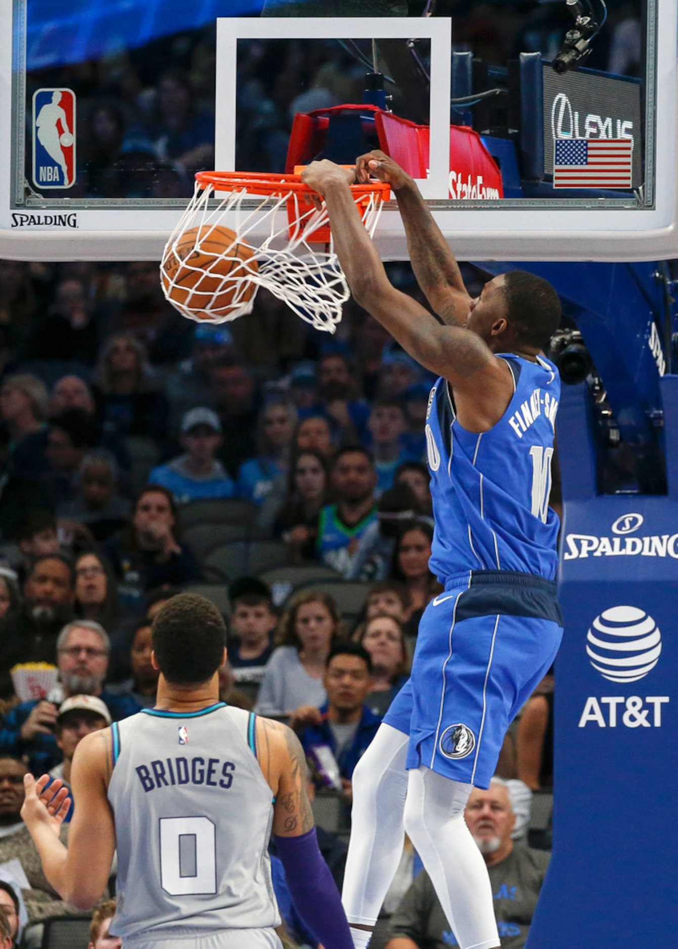 Dallas Mavericks forward Dorian Finney-Smith (10) dunks over Charlotte Hornets forward Miles...