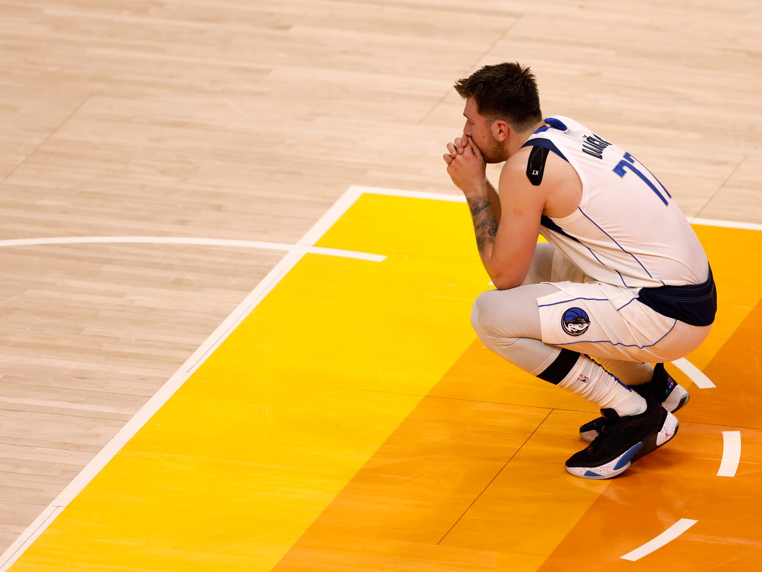 Dallas Mavericks guard Luka Doncic (77) watches at the opposite free throw line as Dallas...