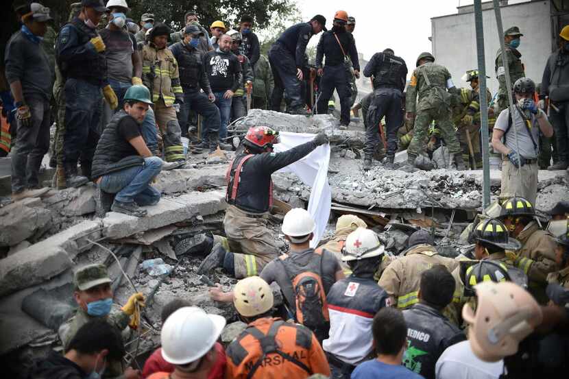 Rescuers, firefighters, policemen, soldiers and volunteers searched for survivors in Mexico...