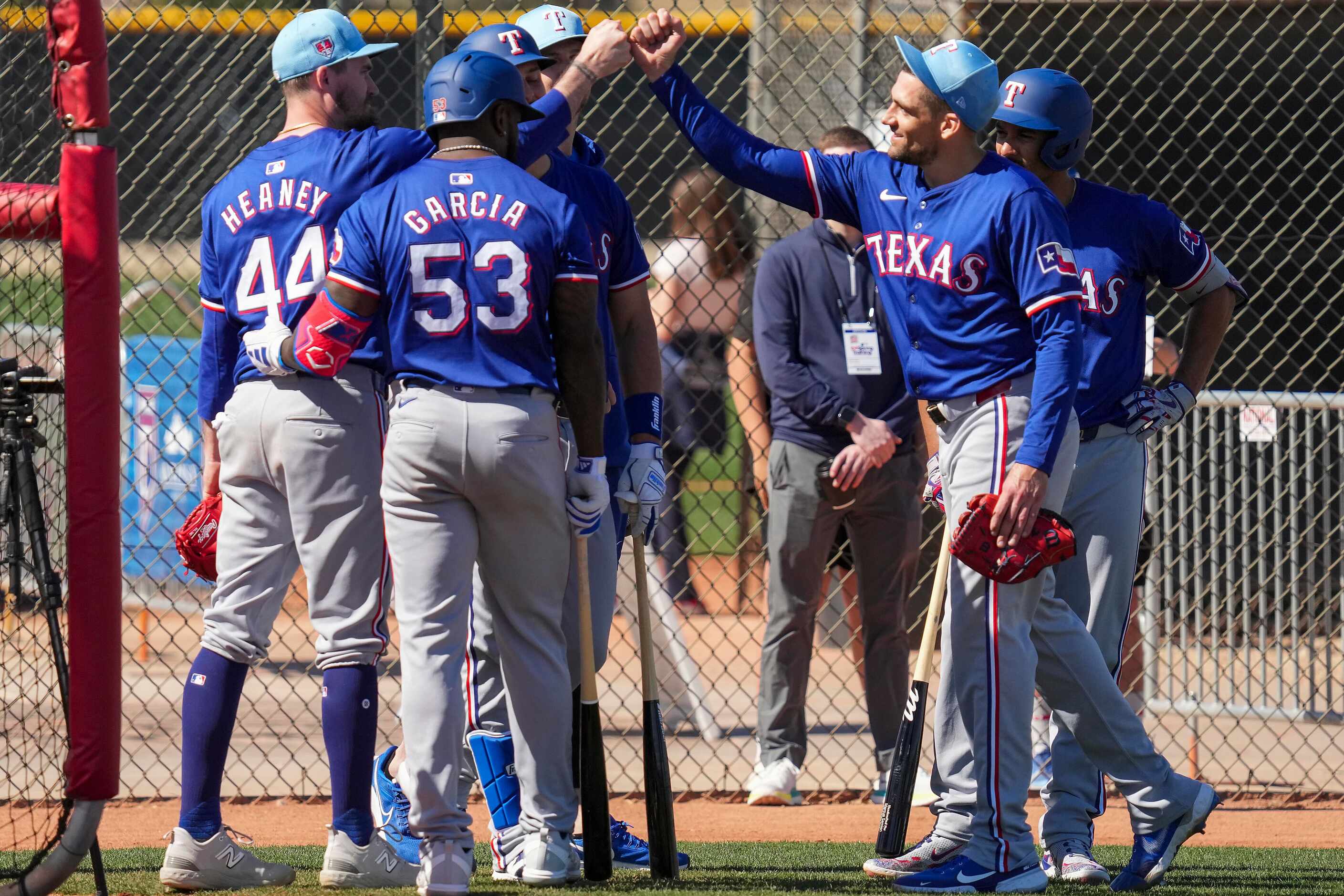 Texas Rangers pitcher Nathan Eovaldi bumps fists with pitcher Andrew Heaney (44) as...