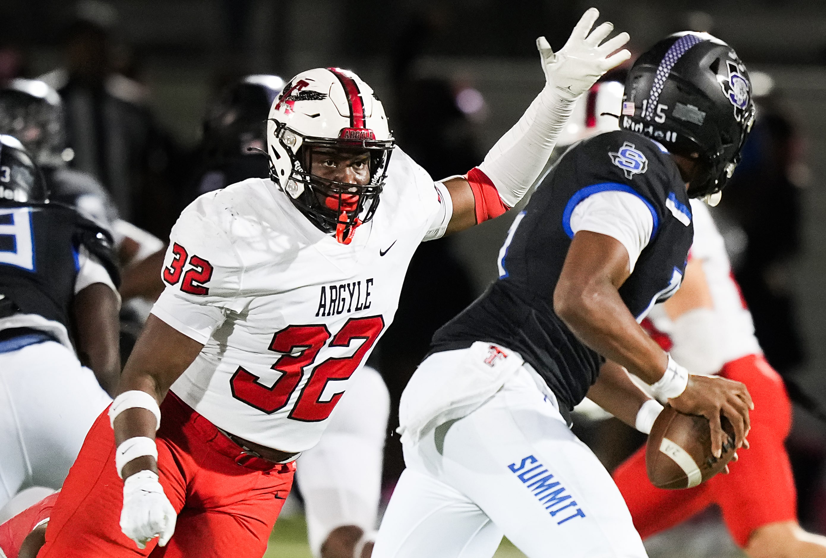 Argyle linebacker Max Bland (32) flushes Mansfield Summit quarterback Demarus Bird (15) from...