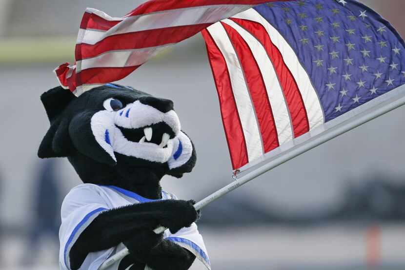 The Denton Guyer mascot waves the American flag during a time out in the fourth quarter...