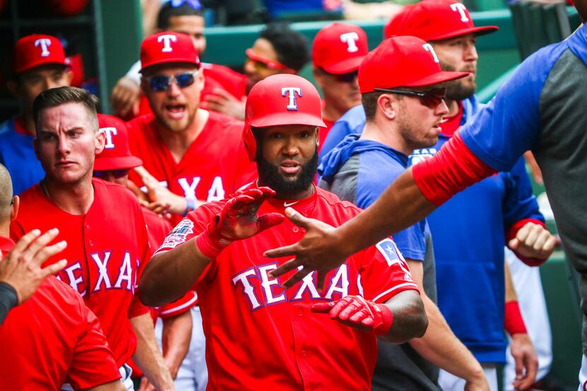 Texas Rangers center fielder Danny Santana (38) is congratulated by his teammates after...