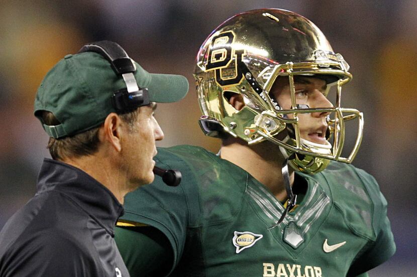 Baylor Bears head coach Art Briles visits with his quarterback Bryce Petty during a timeout...