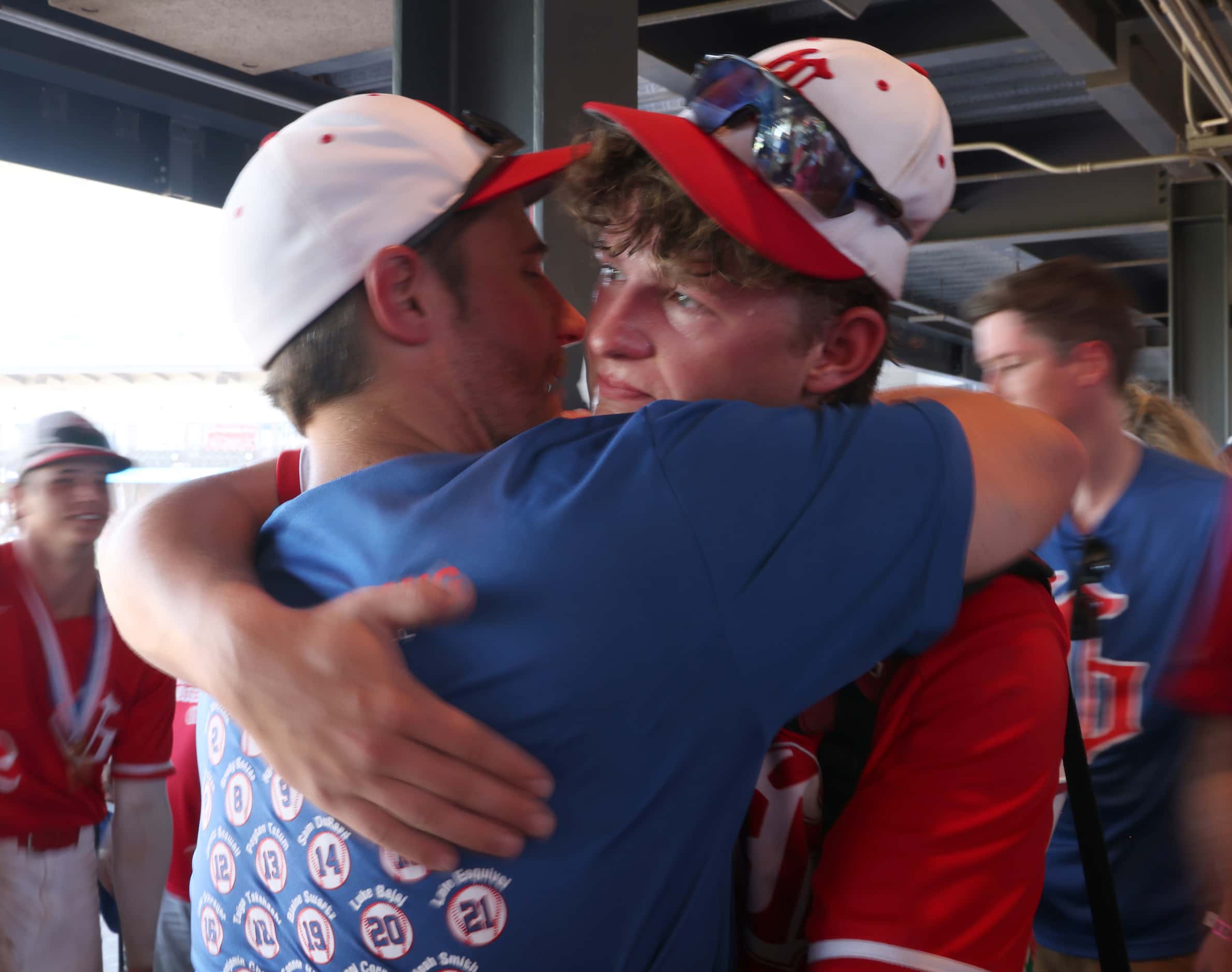 Grapevine pitcher Luke Schreyer (16), right, hugs his father, Andrew Schreyer in the stands...
