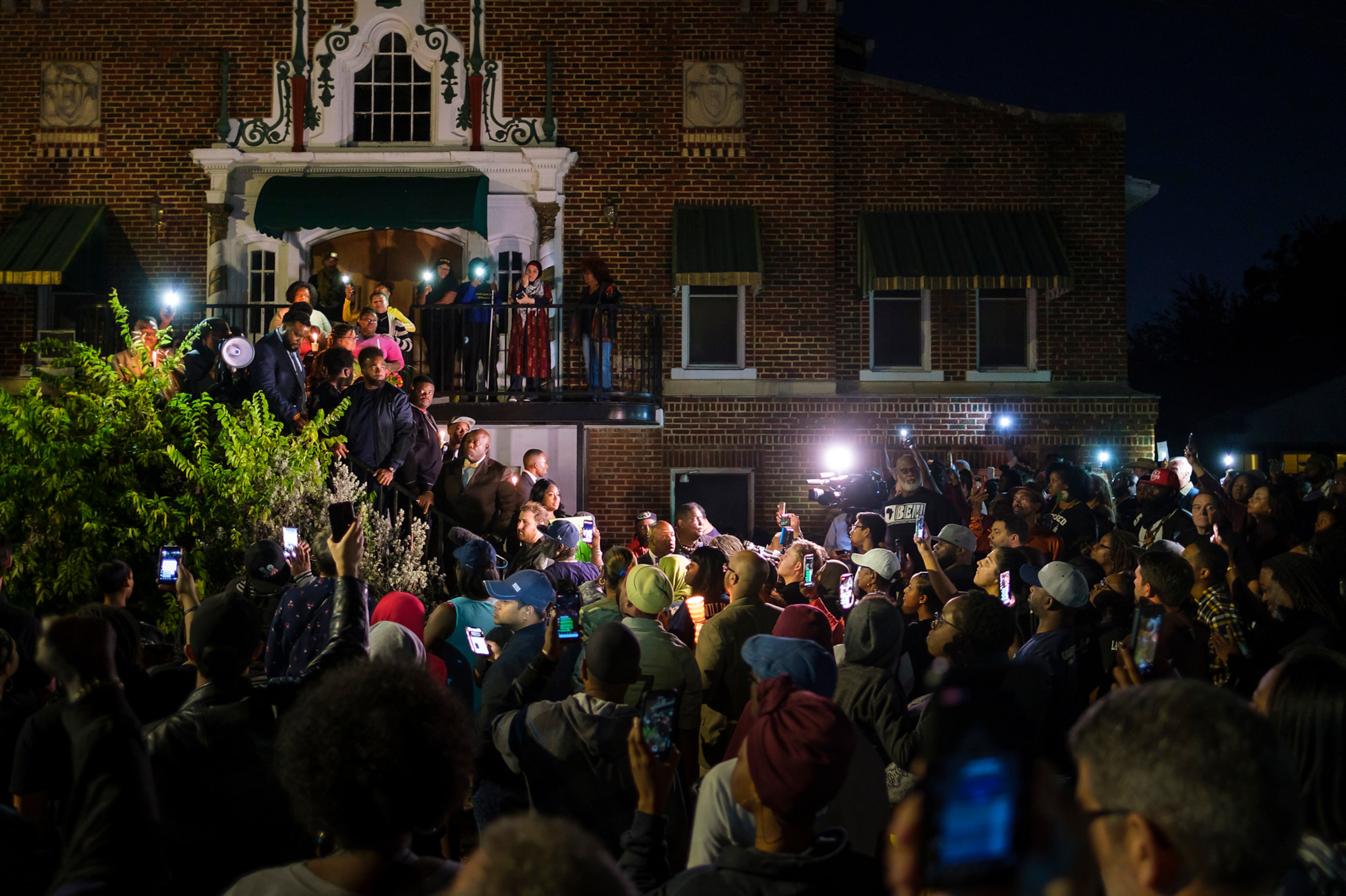 Attorney Lee Merritt stands with members of the victimÕs family on a stairwell as he...