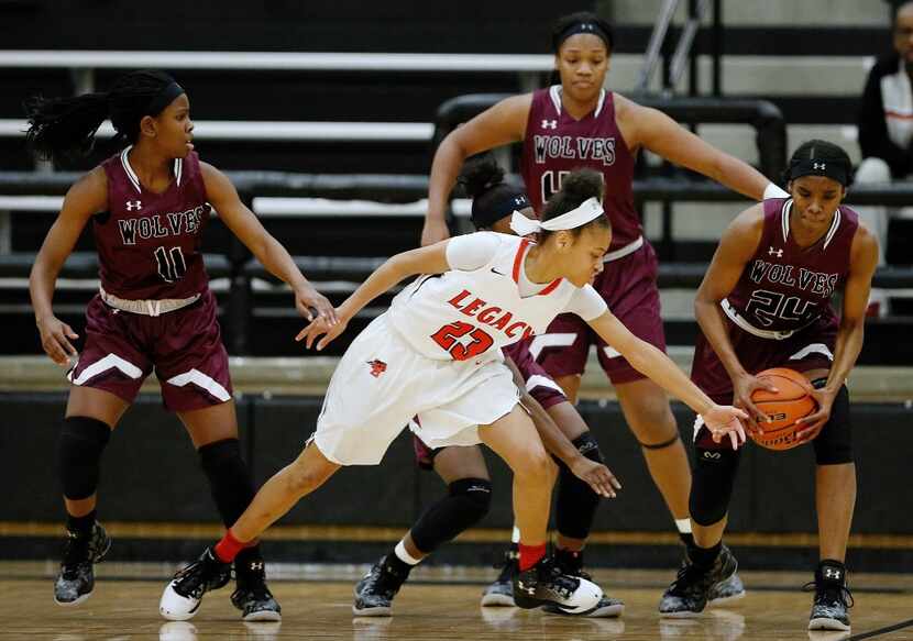 Mansfield Legacy freshman guard Harmoni Turner (23) loses the ball to Mansfield Timberview...
