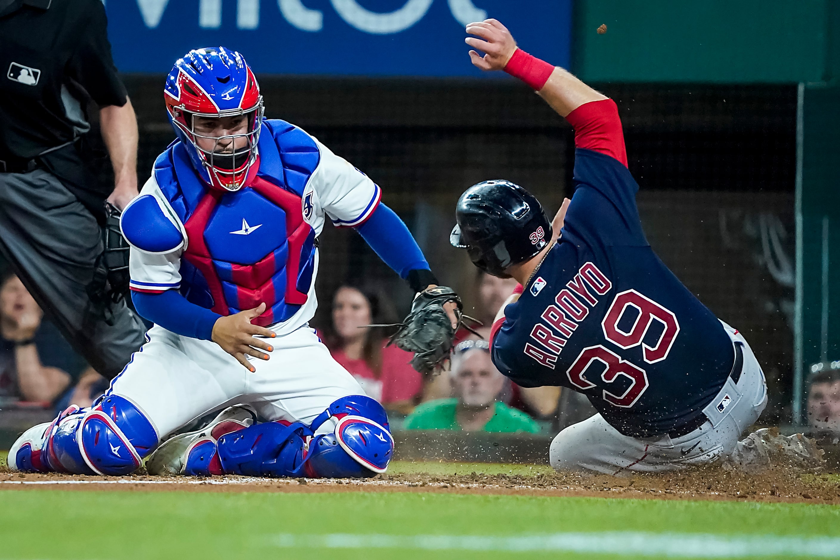 Boston Red Sox second baseman Christian Arroyo scores past the tag from Texas Rangers...