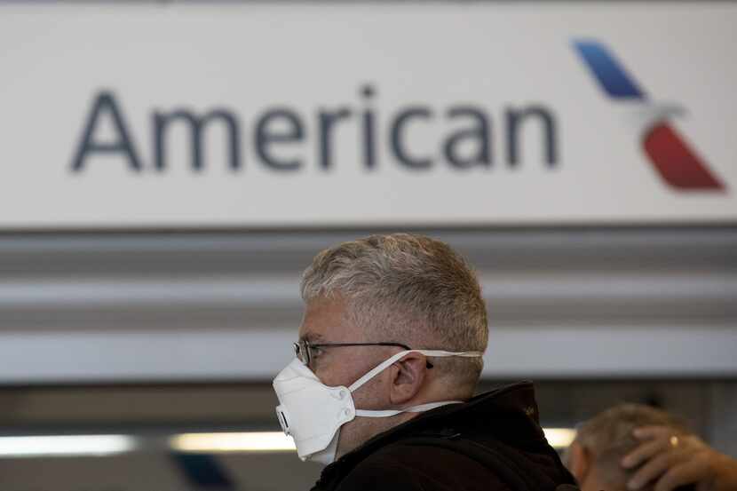 MADRID, SPAIN - MARCH 13: A passenger wearing protective mask queue at customer assistance...