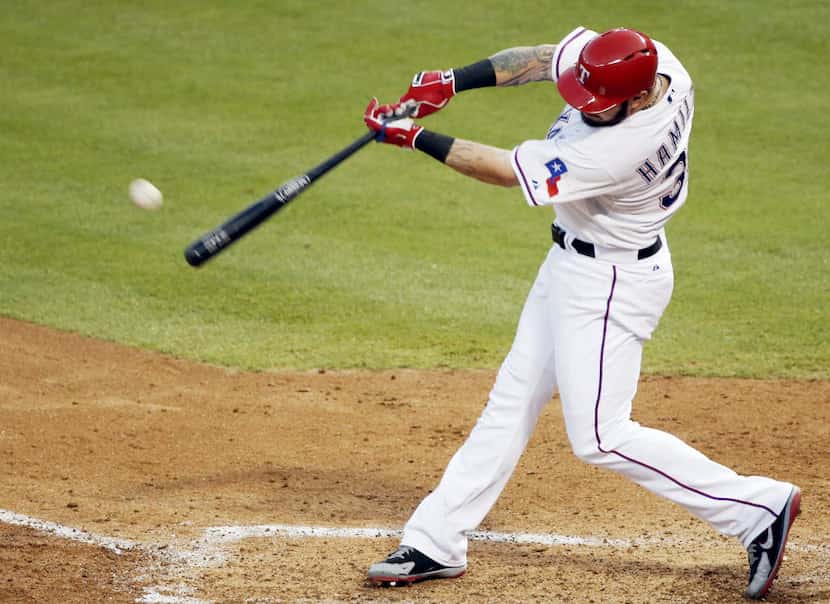 Texas Rangers Josh Hamilton makes contact for a solo home-run during the fourth inning of a...