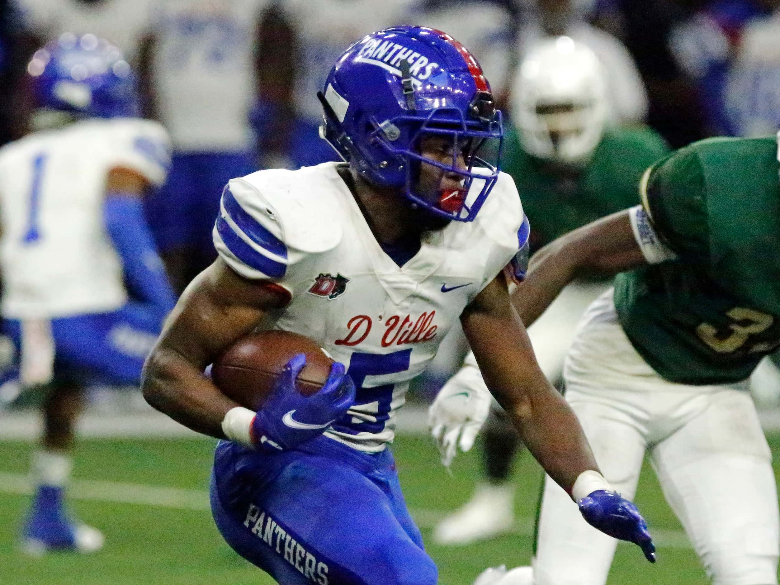 Duncanville High School Malachi Medlock (5) carries the football during the first half as...