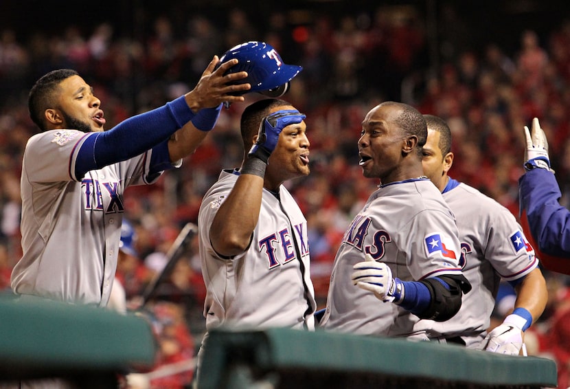 Texas Rangers shortstop Elvis Andrus (left) goofs with third baseman Adrian Beltre (center)...