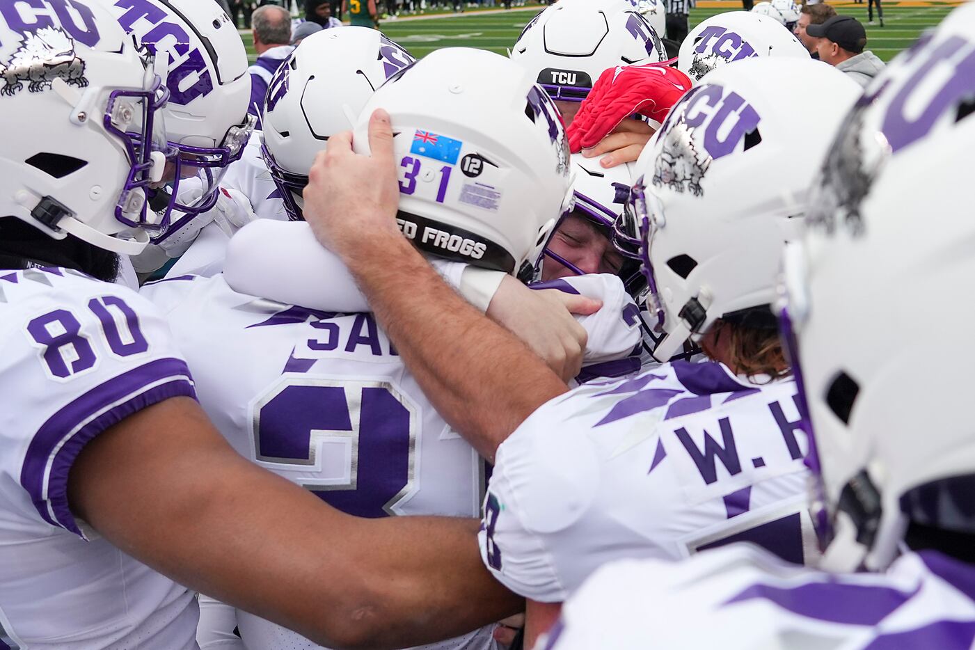 TCU kicker Griffin Kell (facing, center) is mobbed by teammates after kicking a game-winning...