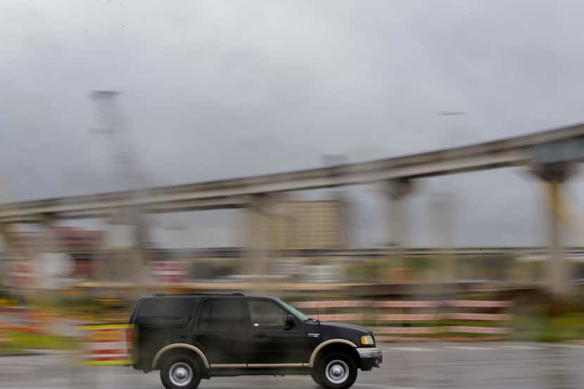 A truck drives past a bridge under construction near State Highway 360 and Interstate 30 in...