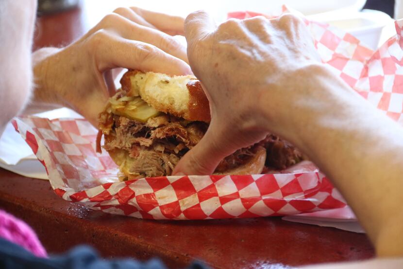 Digging in to a sandwich at One90 Smoked Meats.