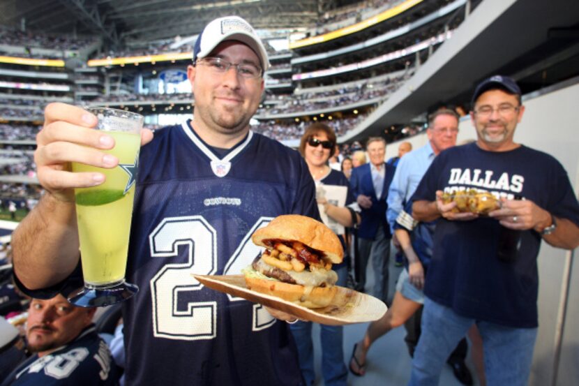 Eddie Watson of Mansfield showed off his hamburger and margarita before the start of the...