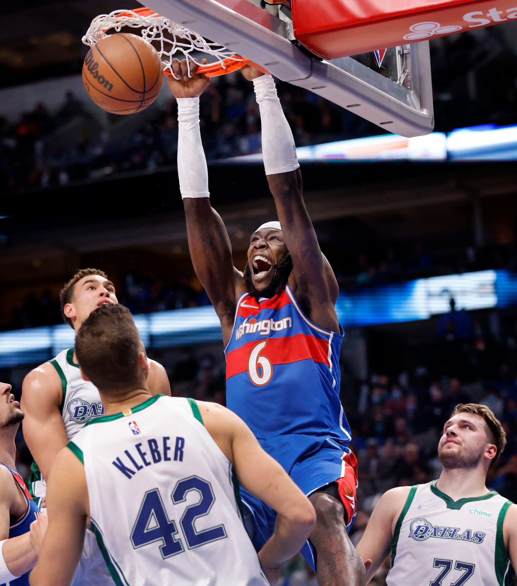 Dallas Mavericks center Kristaps Porzingis (6) dunks over Dallas Mavericks forward Maxi...