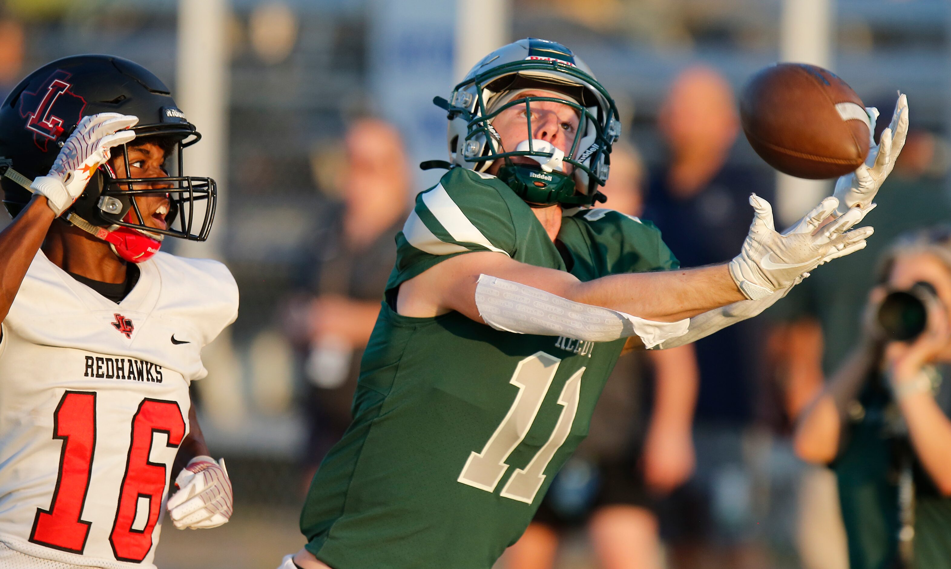 Reedy High School wide receiver A.J. Jayroe (11) gets behind Liberty High School cornerback...