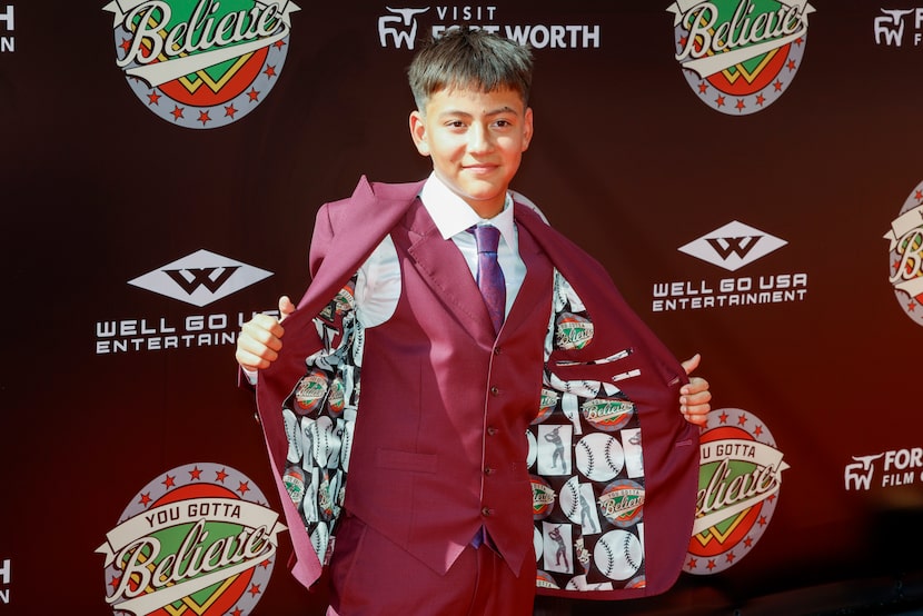 Actor Jacob Mazeral shows off his custom suit jacket featuring the “You Gotta Believe” movie...