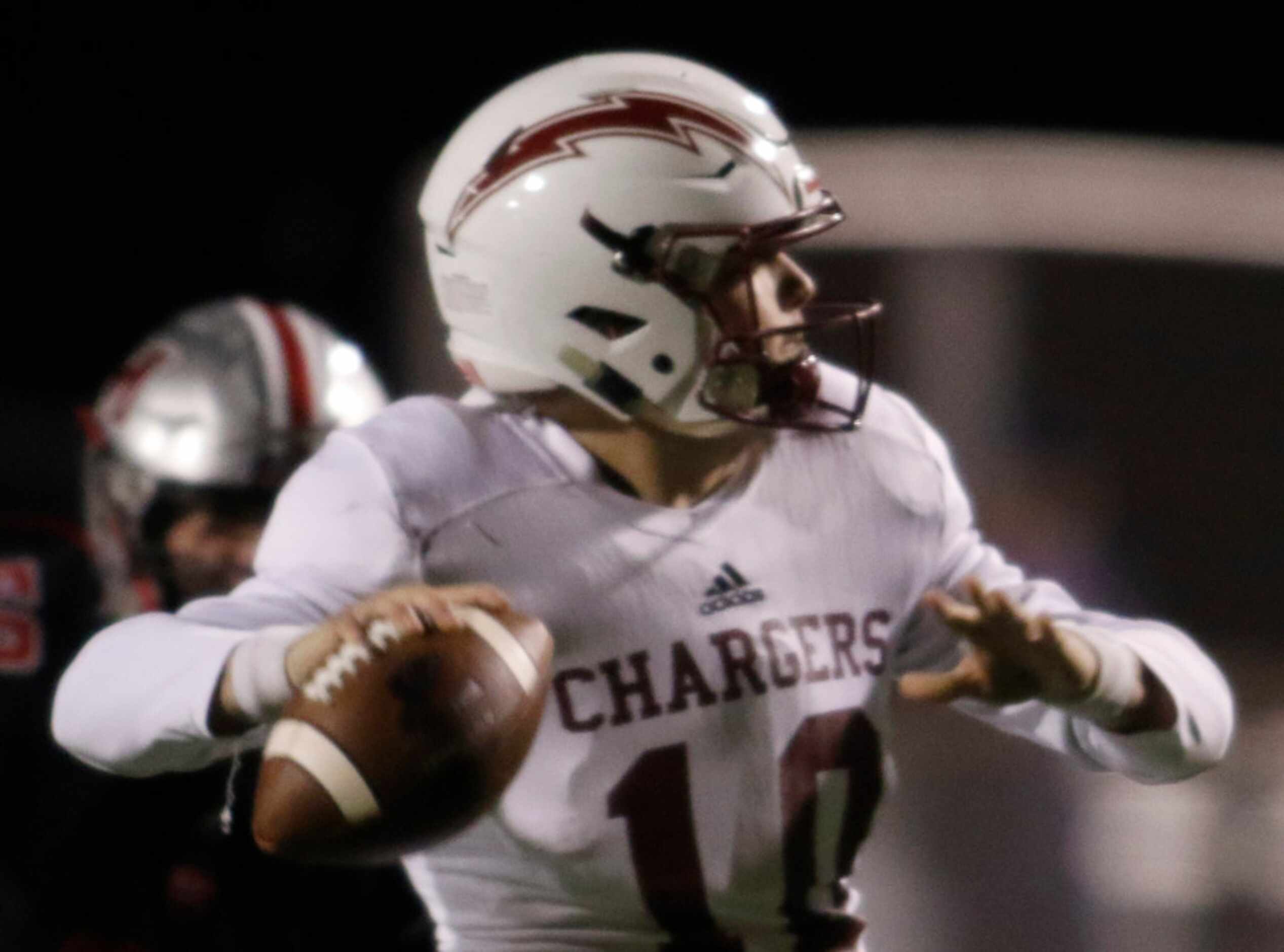 Keller Central quarterback Gavyn White (10) looks to pass during first quarter action...