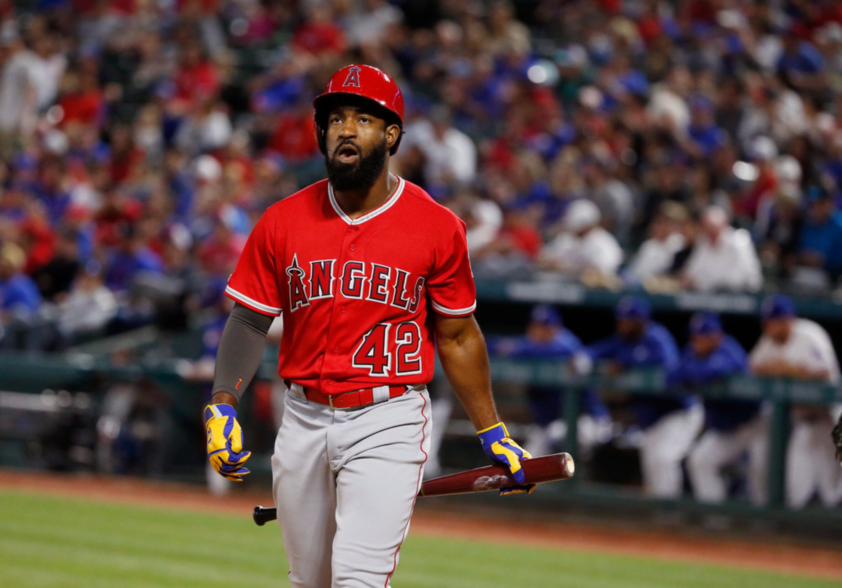 Los Angeles Angels center fielder Brian Goodwin walks back to the dugout after striking out...