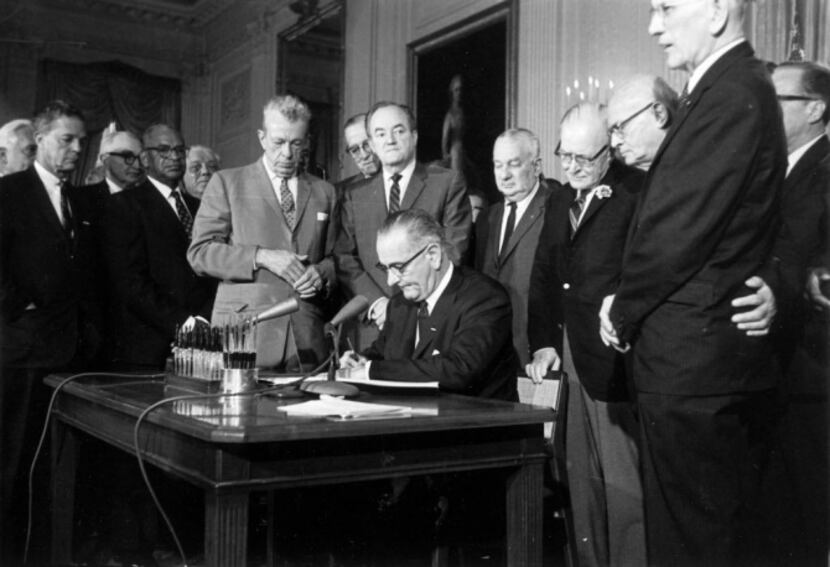 President Lyndon Johnson signed the Civil Rights Act in the White House in 1964. Some doubt...
