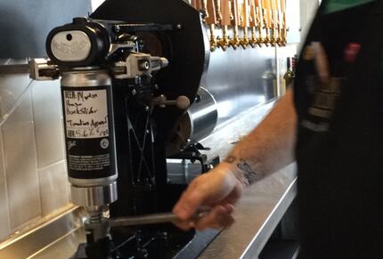 A bartender at Whole Foods Park Lane seals a crowler. It takes less than 20 seconds.