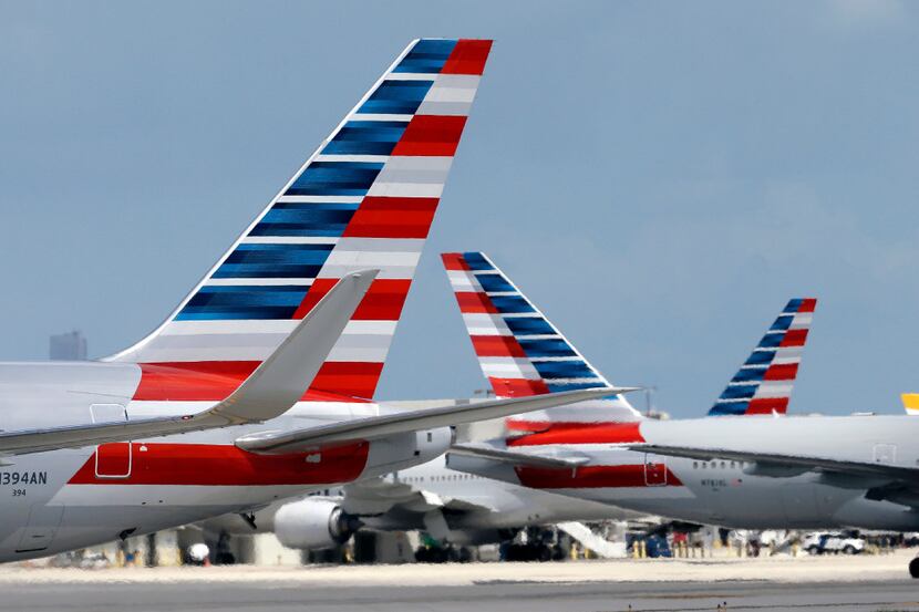 FILE - In this May 27, 2015, file photo, American Airlines jets taxi at Miami International...