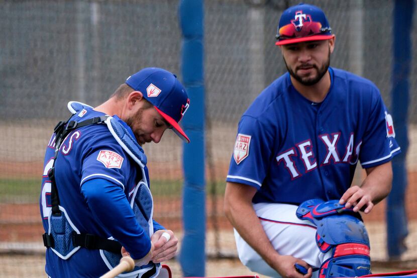 Texas Rangers catchers Isiah Kiner-Falefa (right) and Jeff Mathis prepare to catch a bullpen...