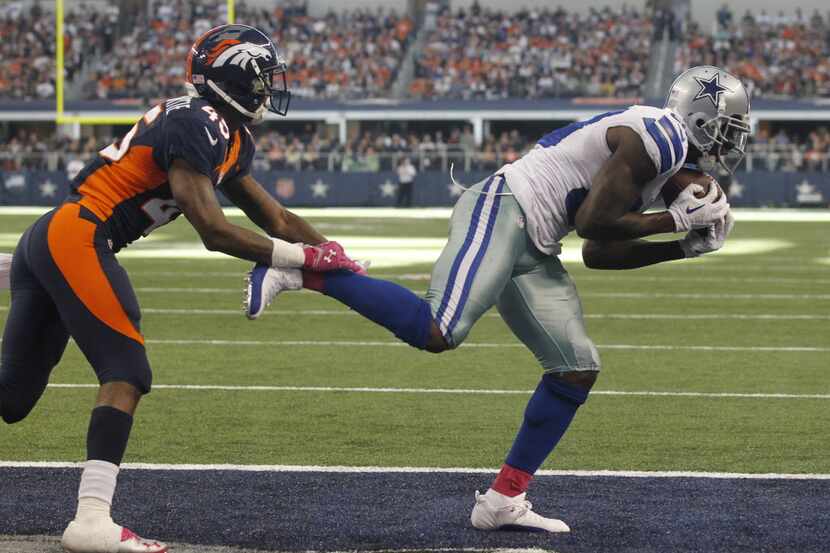 Dallas Cowboys wide receiver Dez Bryant (88) scores a touchdown in front of Denver Broncos...