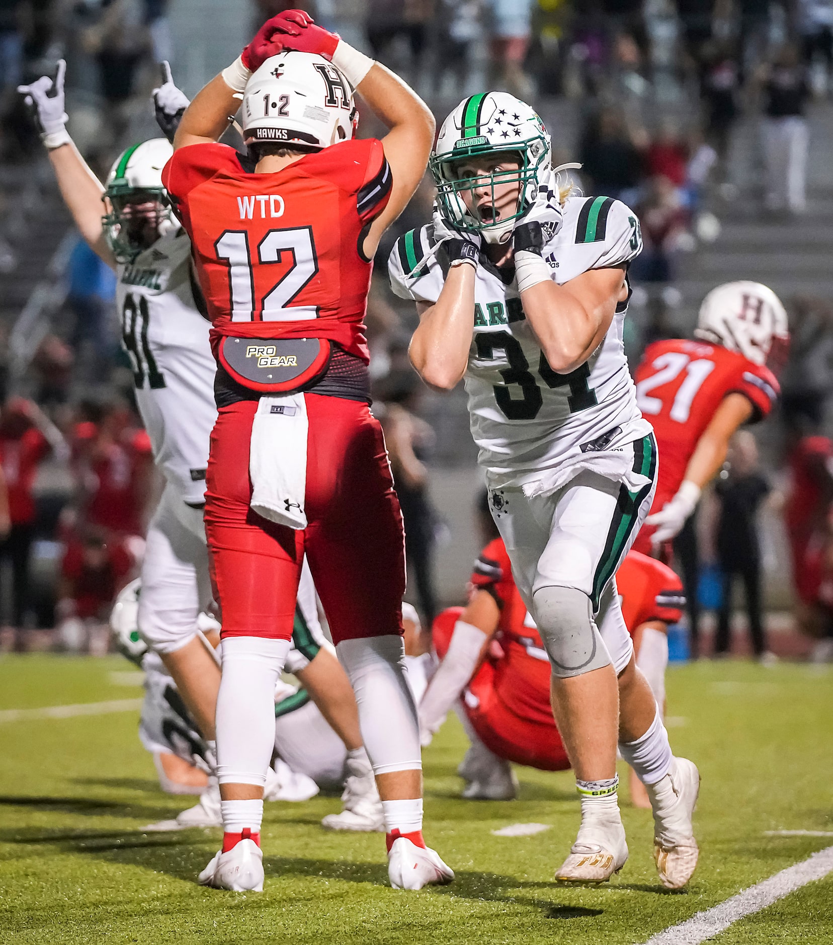 Southlake Carroll defensive linemen Travis Keener (34) and Calder Bray (91) celebrate after...