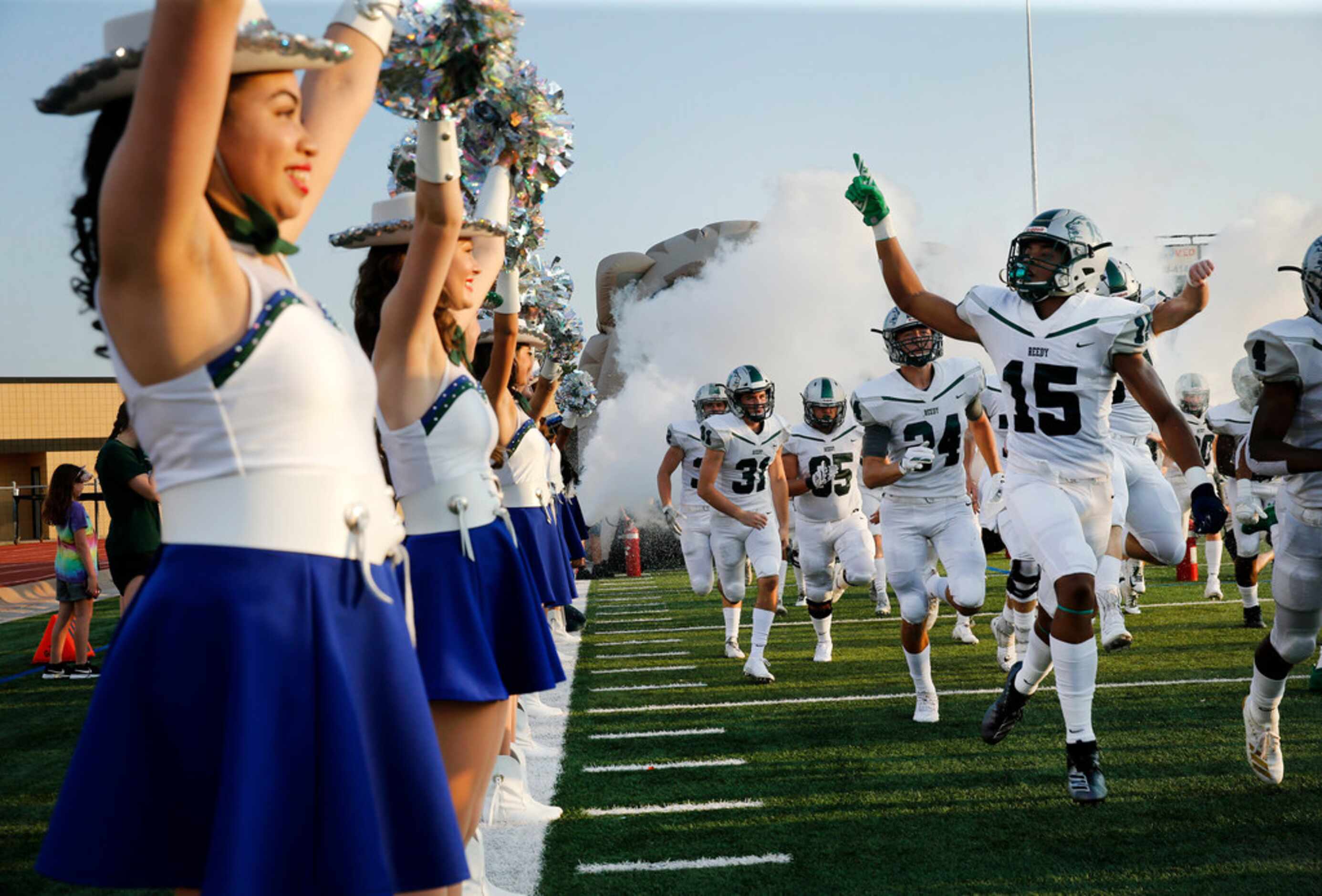 Frisco Reedy's Zion Washington (15) and the rest of the Lions take the field lined by the...