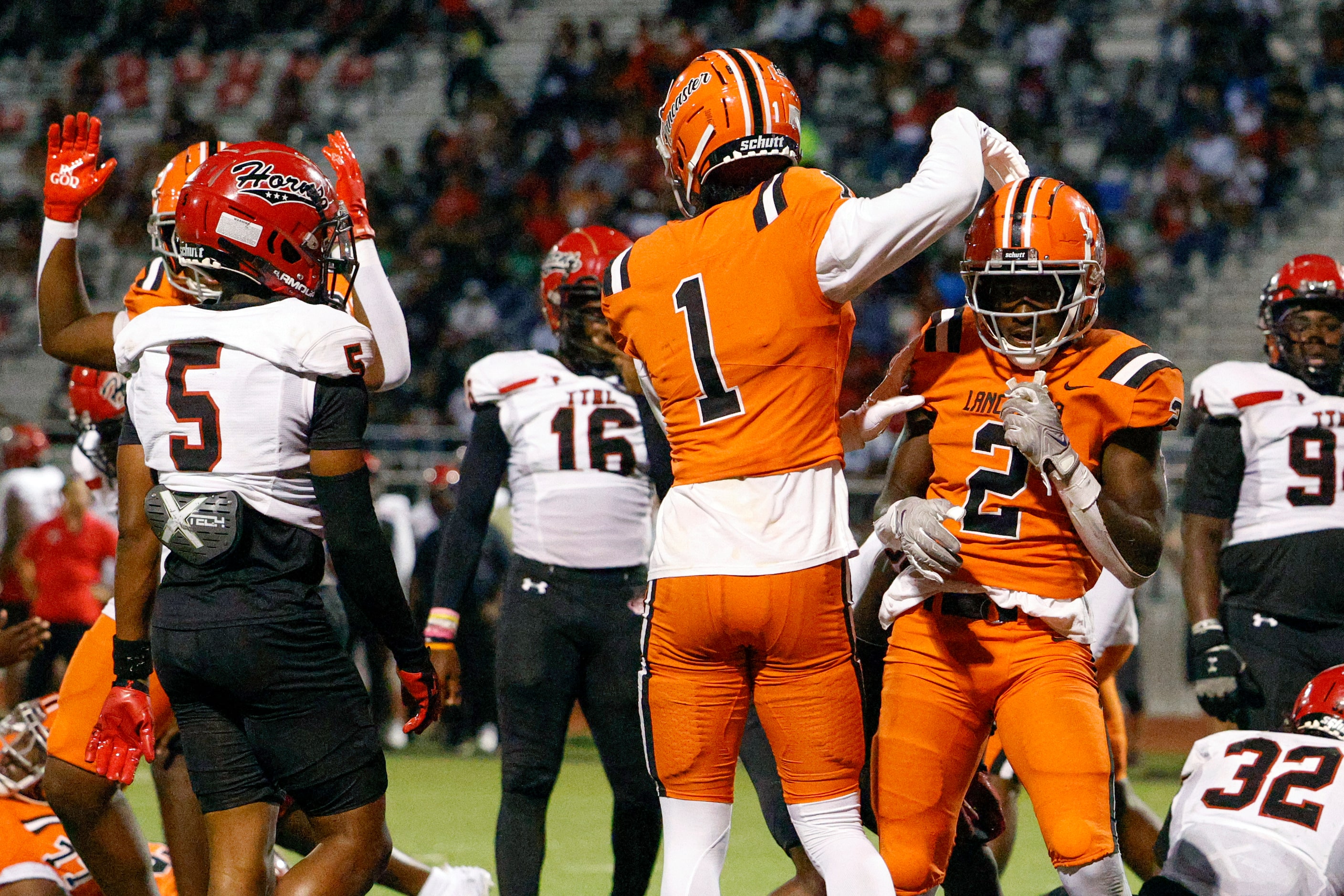 Lancaster running back Izayah Lee (2) celebrates his rushing touchdown with wide receiver...