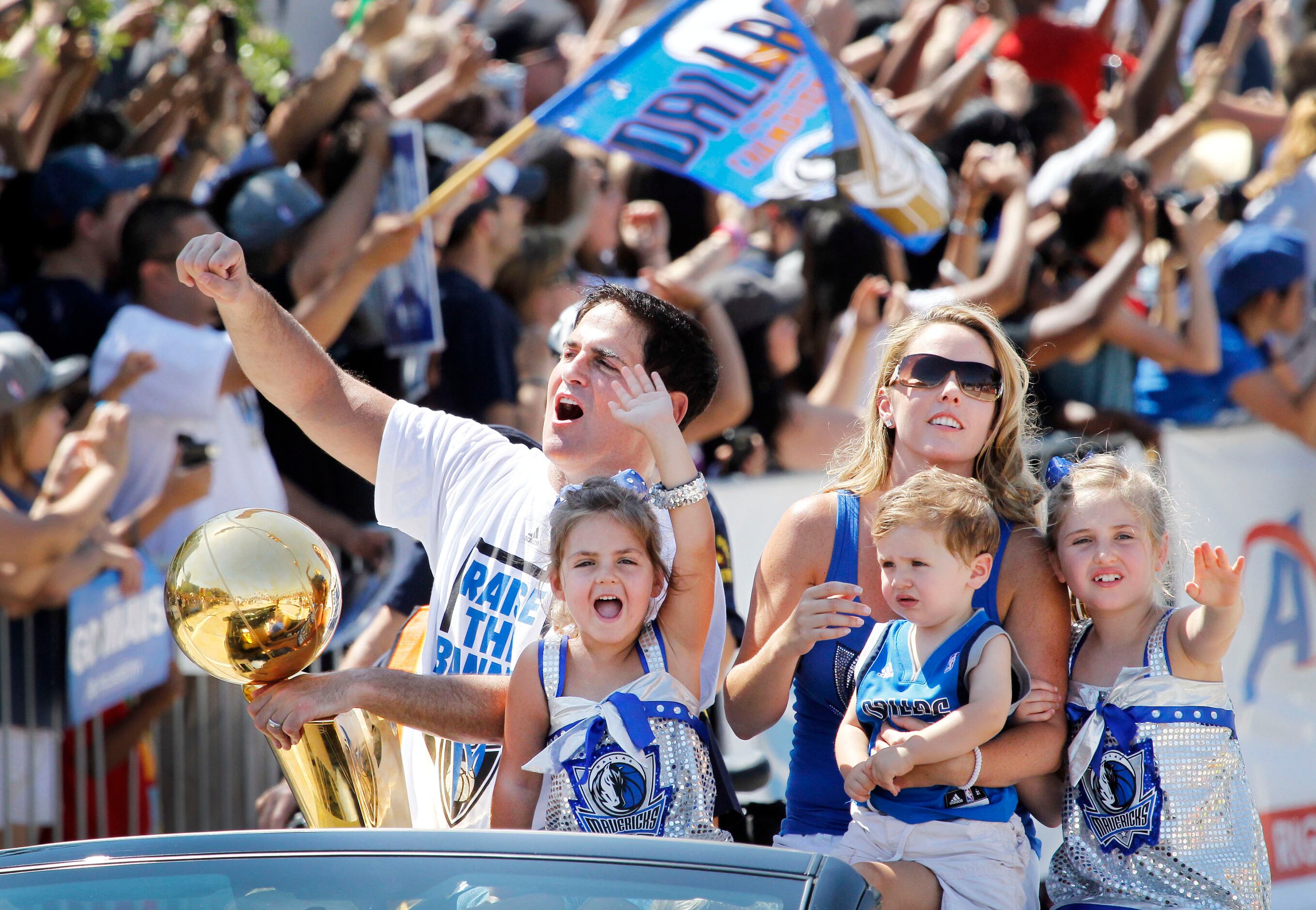 June 16, 2011: Mark Cuban rides with his family along the parade route near the American...