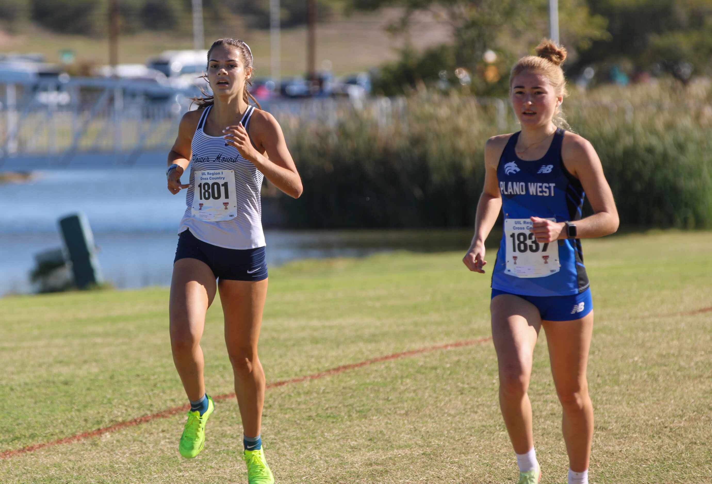 Flower Mound’s Nicole Humphries (left) and Plano West’s Haley Harper head to the finish line...