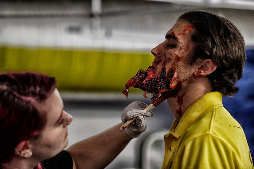 Dash Porter receives the final touches on a prosthetic chin, backstage at Halloween Horror...