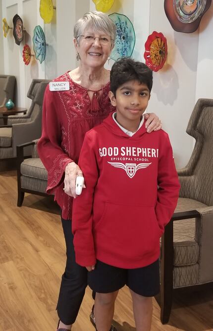 Nancy Miller and Ahan Jain pose for a picture after a pizza party at Presbyterian Village...