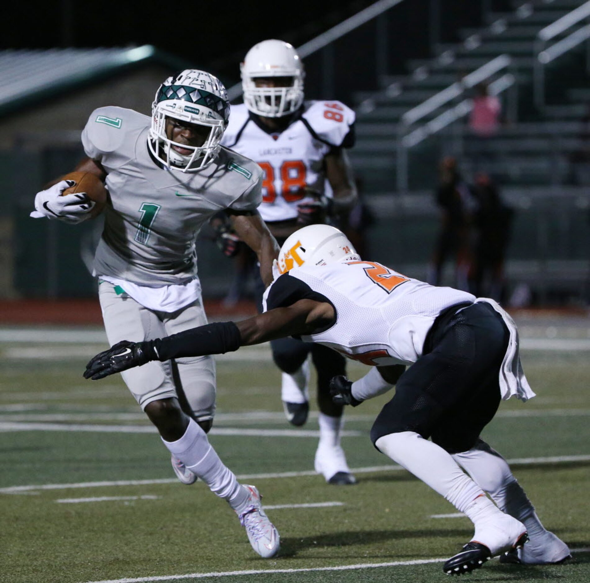 Waxahachie wide receiver Jalen Reagor (1) avoids a tackle by Lancaster defensive back...