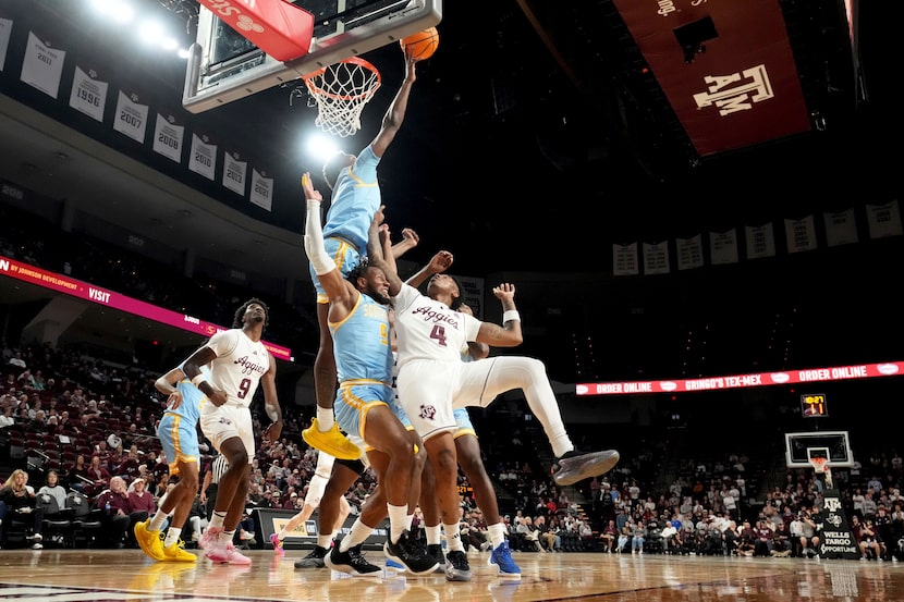 Southern University forward Derrick Tezeno, left top, blocks a shot attempt by Texas A&M...