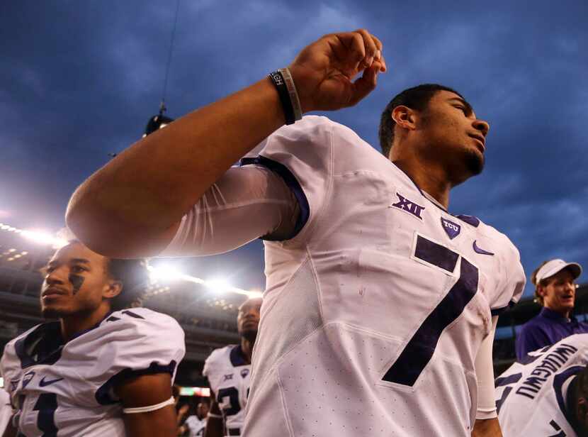 TCU quarterback Kenny Hill does the horned frog gesture as the band plays the alma mater...