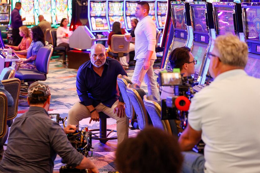 Former Texas Rangers catcher Ivan 'Pudge' Rodriguez signals his drink order to a waitress...