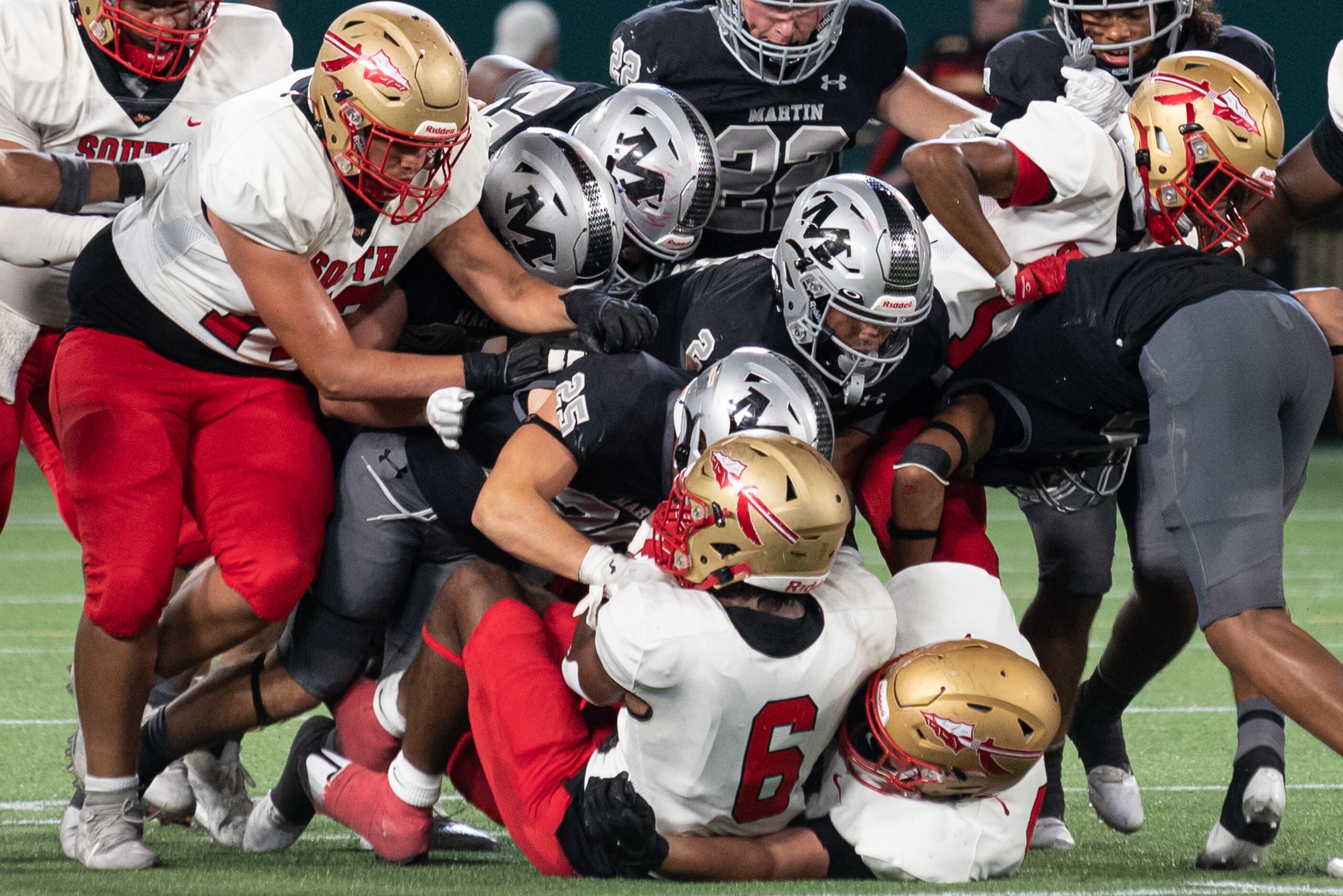 South Grand Prairie senior running back AJ Newberry (6) is tackled by a gang of Arlington...