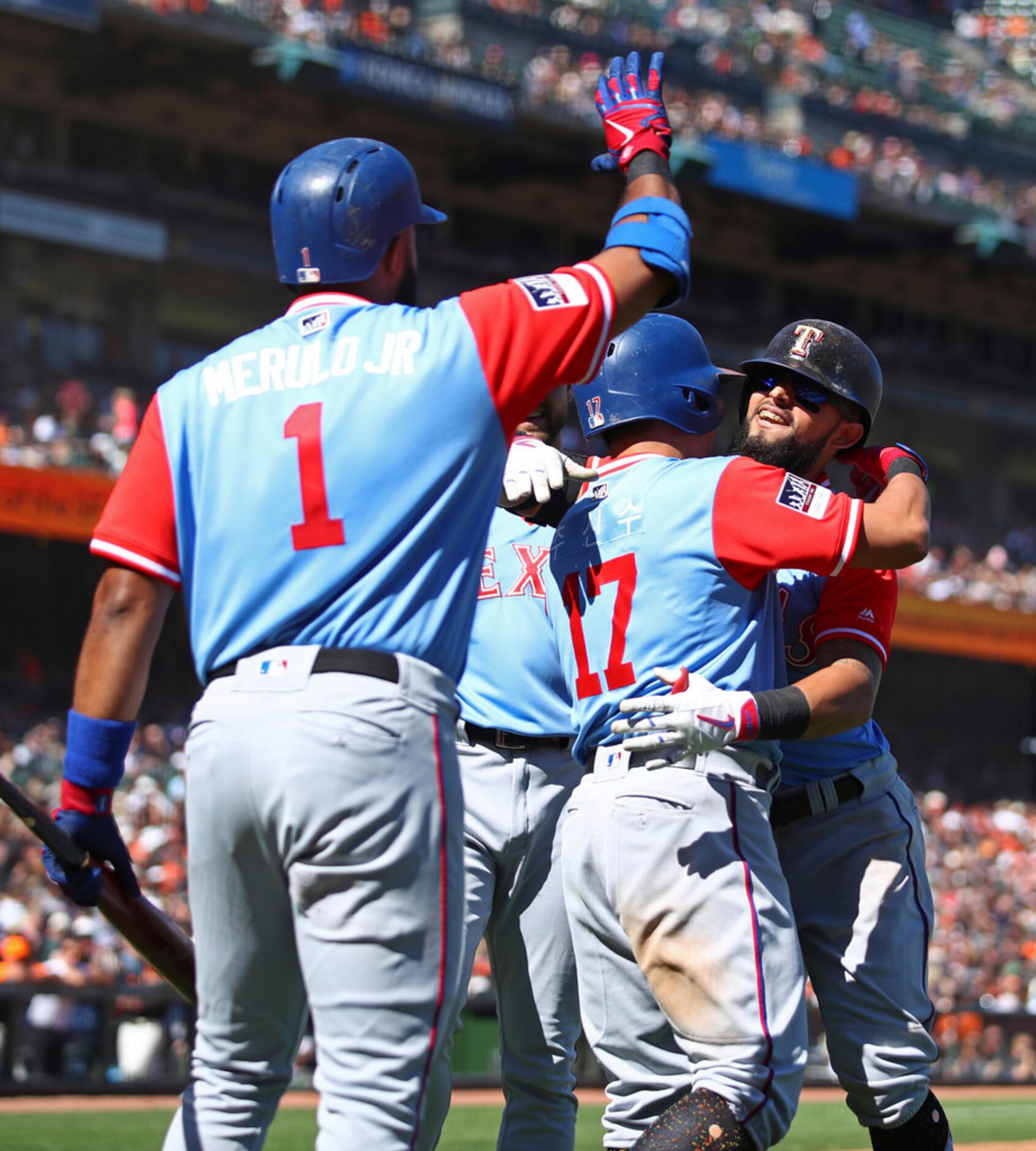 Texas Rangers' Rougned Odor, right, celebrates with Shin-Soo Choo (17) and Elvis Andrus (1)...