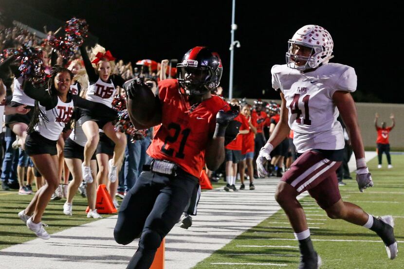 Plano defender JJ Lee (41) watchs as Euless Trinity's Courage Keihn (21) scores a rushing...