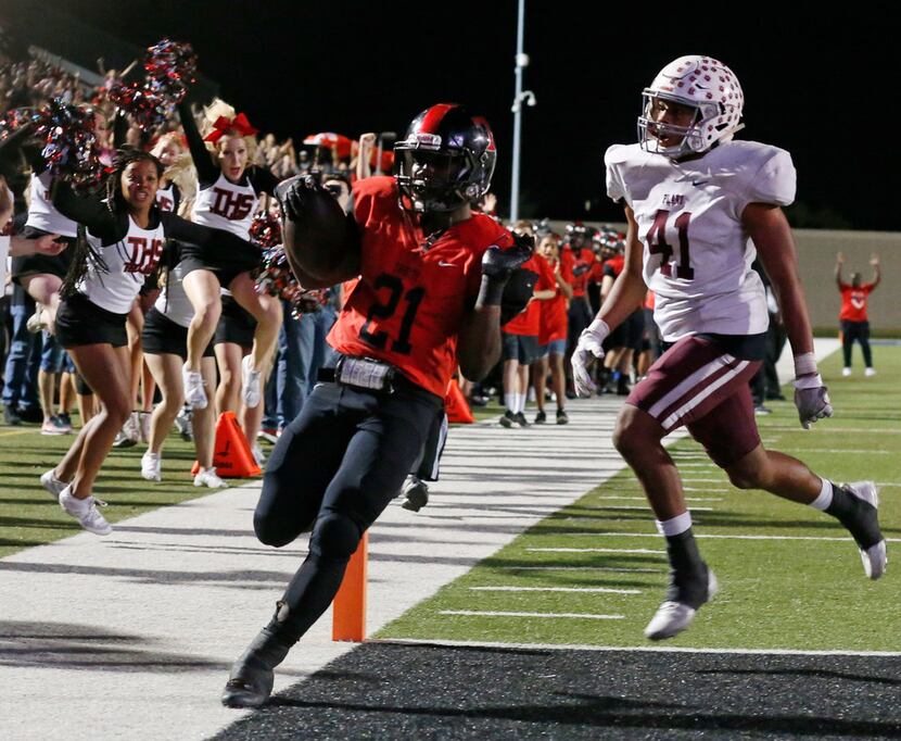Plano defender JJ Lee (41) watchs as Euless Trinity's Courage Keihn (21) scores a rushing...
