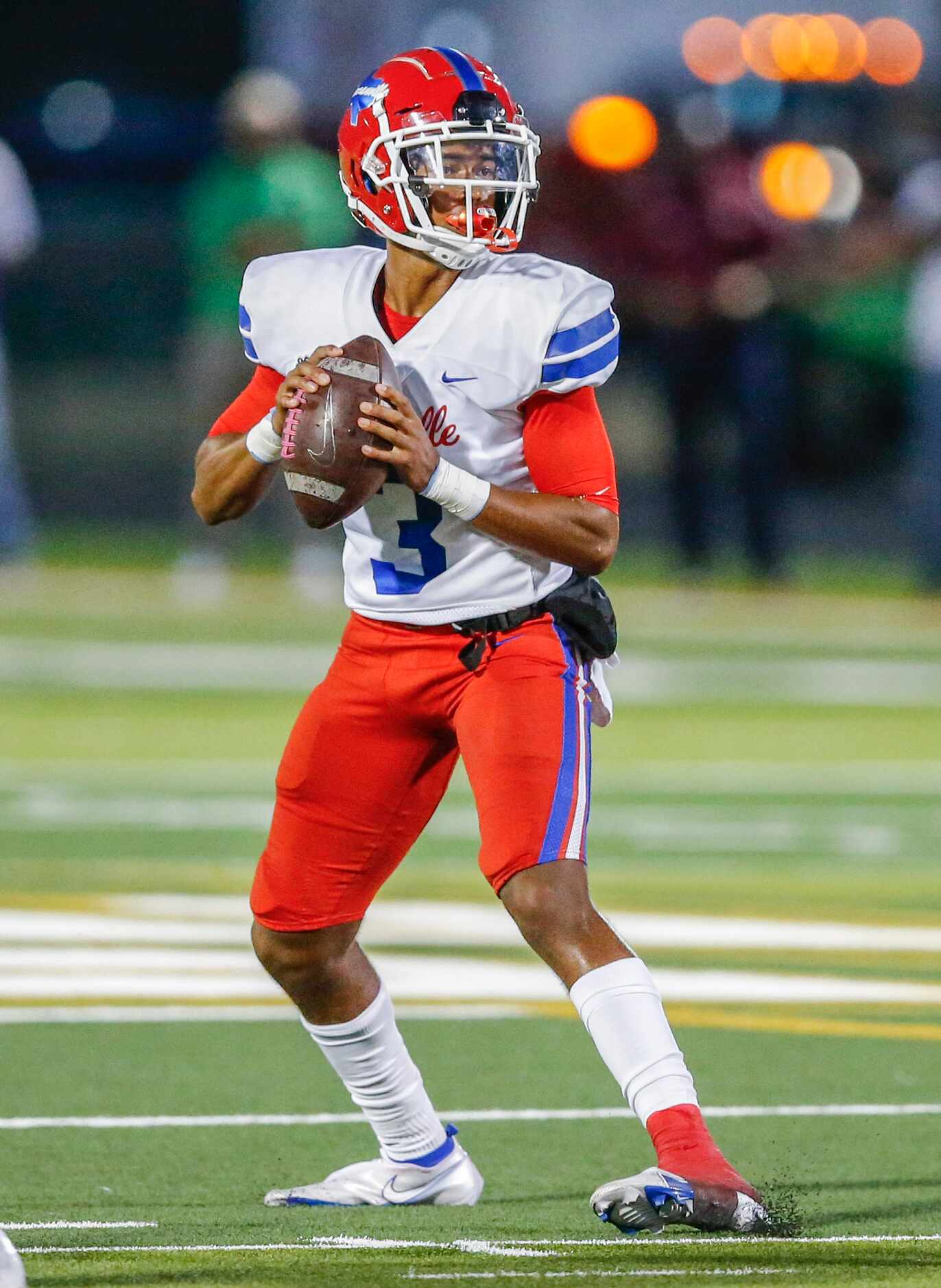 Duncanville senior quarterback Solomon James (3) looks for an open receiver during the first...