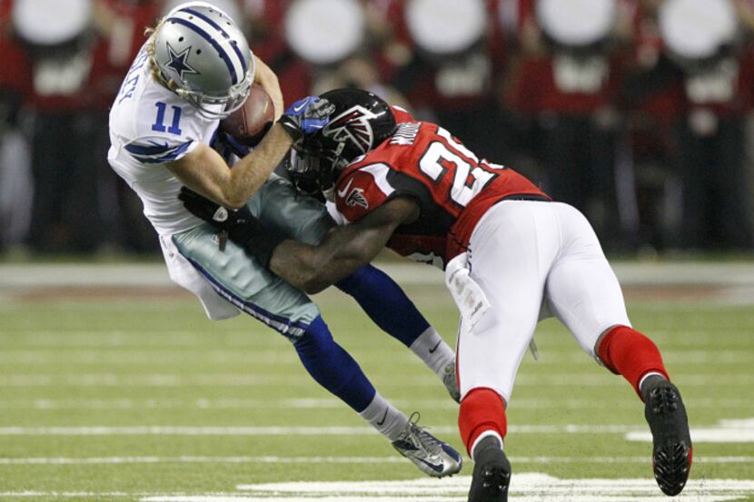 Dallas Cowboys wide receiver Cole Beasley (11) takes a hit from Atlanta Falcons strong...