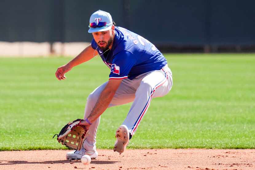 Texas Rangers infielder Jonathan Ornelas participates in a fielding drill during a spring...
